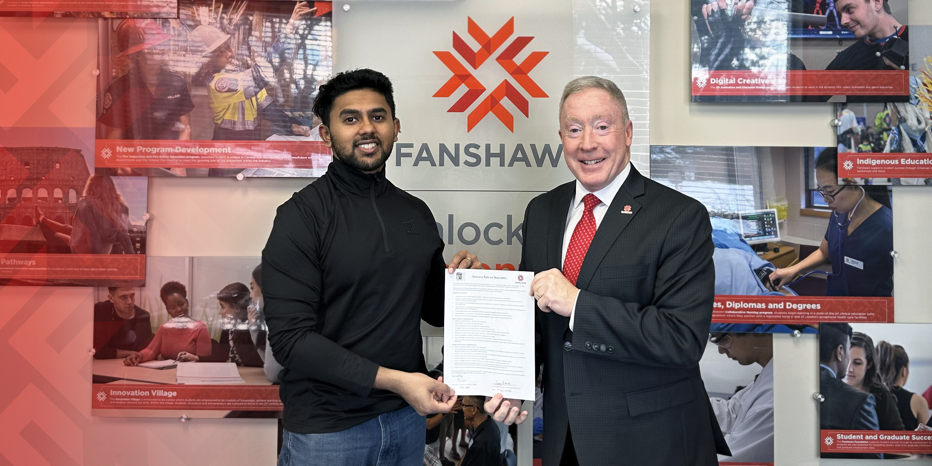Photo of two men in formal clothing holding a document