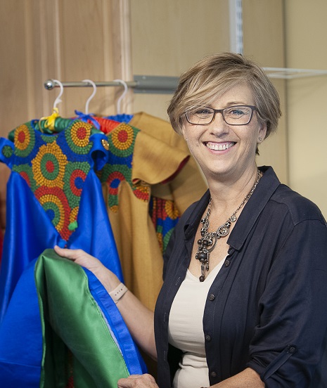 Kelly Scott with her children's clothing she designs and sews