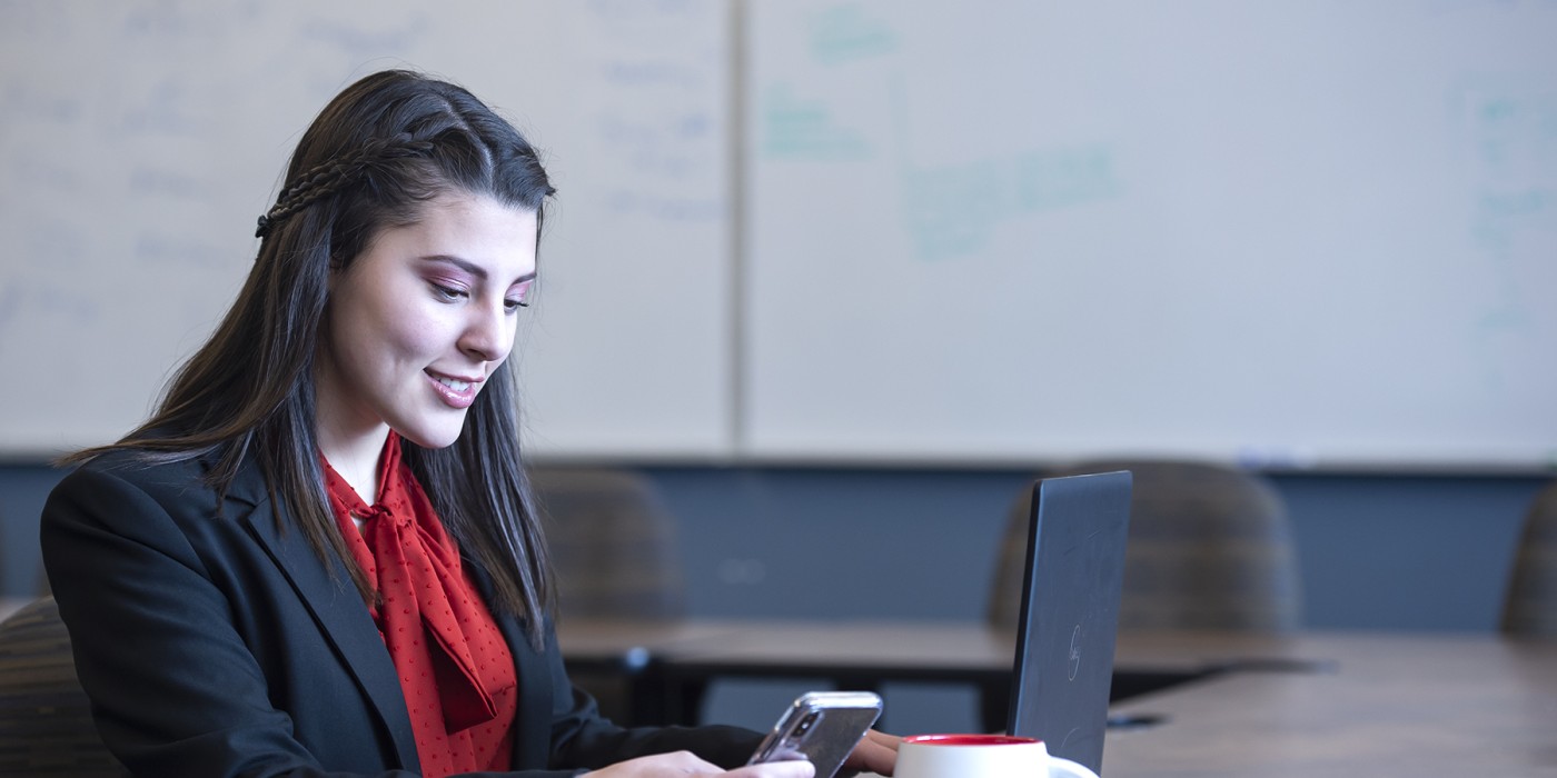 checking cell phone at desk