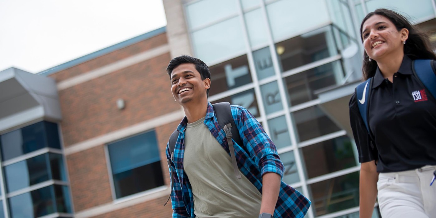Two students walking outside