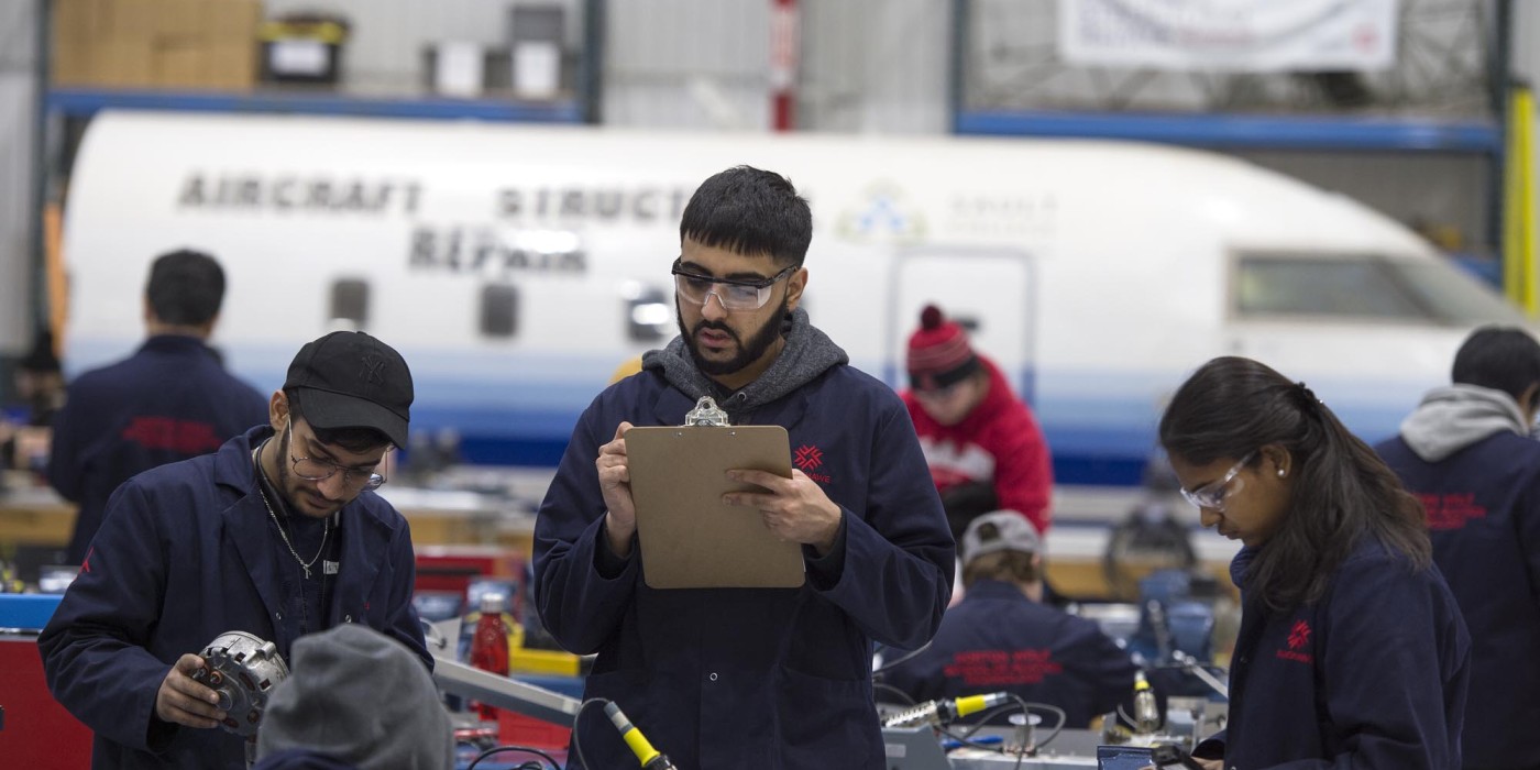 Aircraft Structural Repair Technician students working at the Jazz Hangar at Fanshawe College