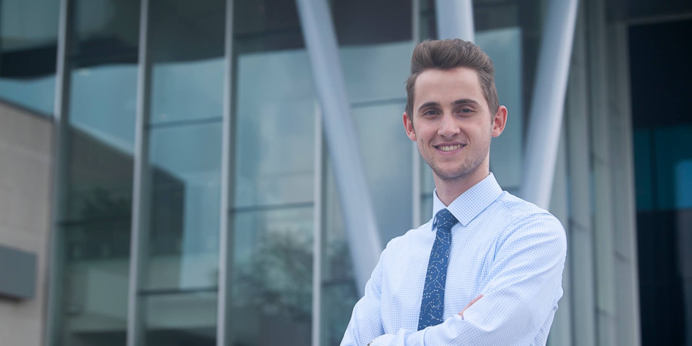 Liam Krusky posing in front of a building