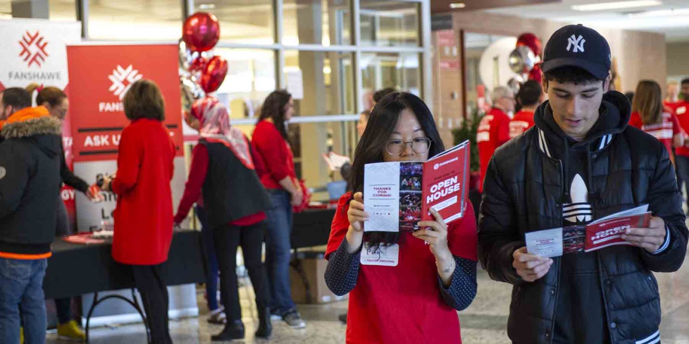 Students looking at brochure at open house