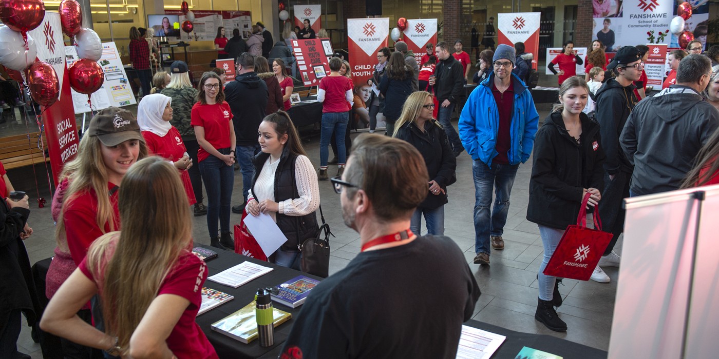 People visiting booths at open house at Fanshawe