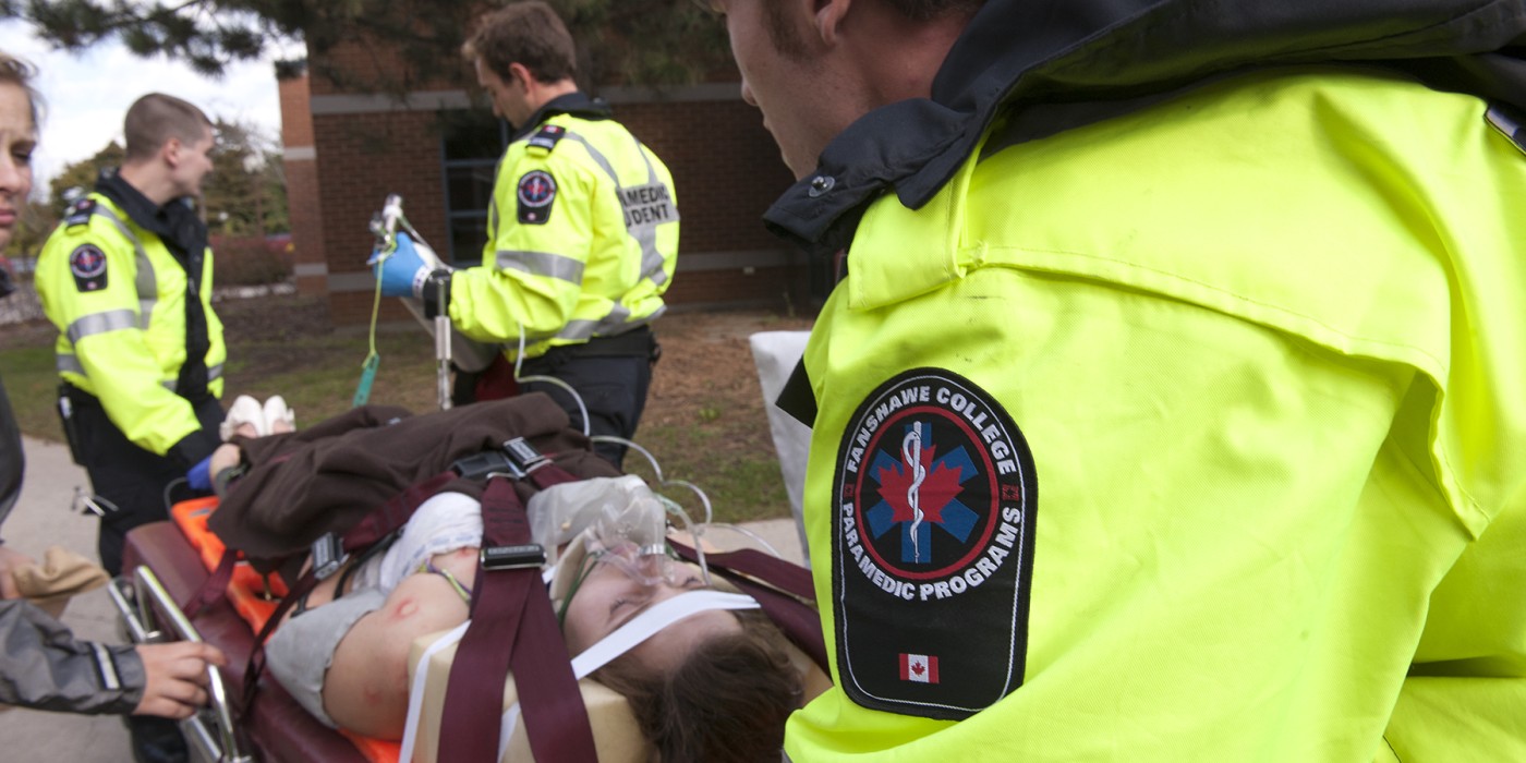 paramedic students tending to a patient during a training exercise.