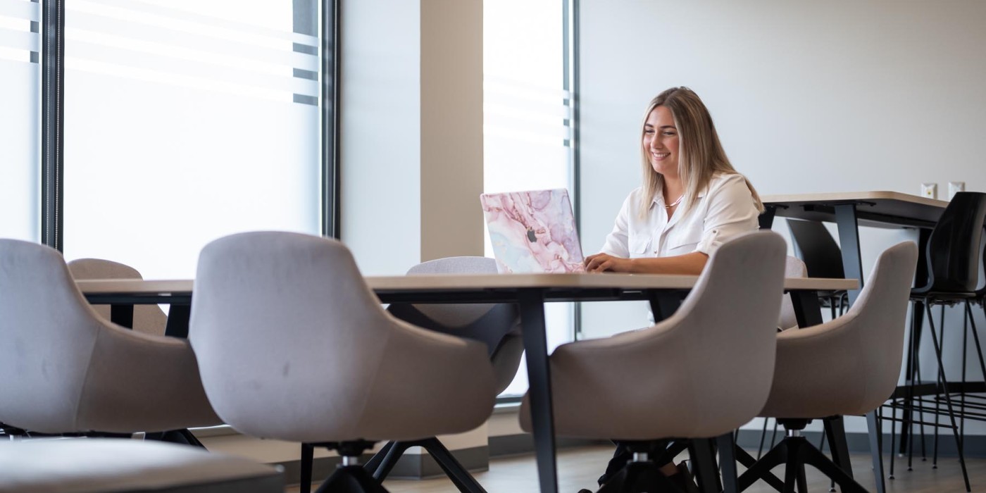 Student at laptop in an office