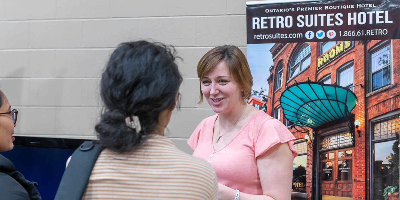 Students speaking with an employer at the job fair
