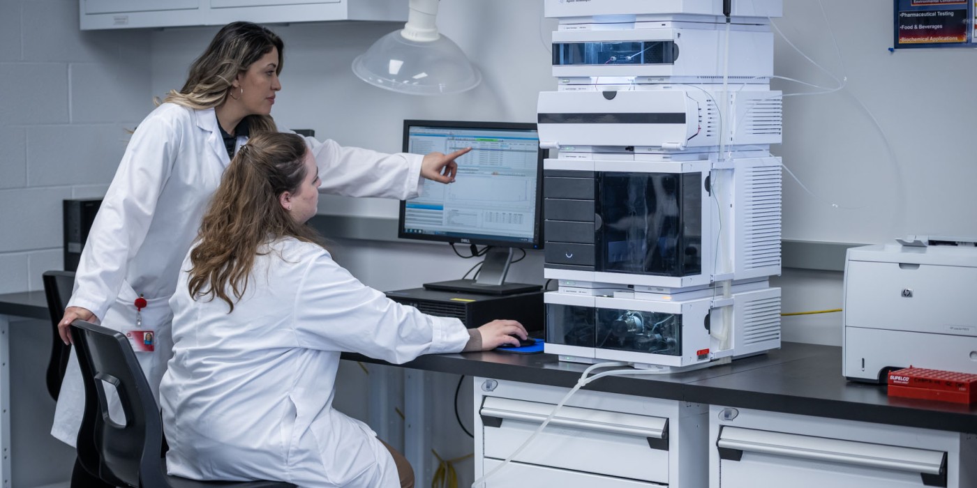 Researchers looking at a computer