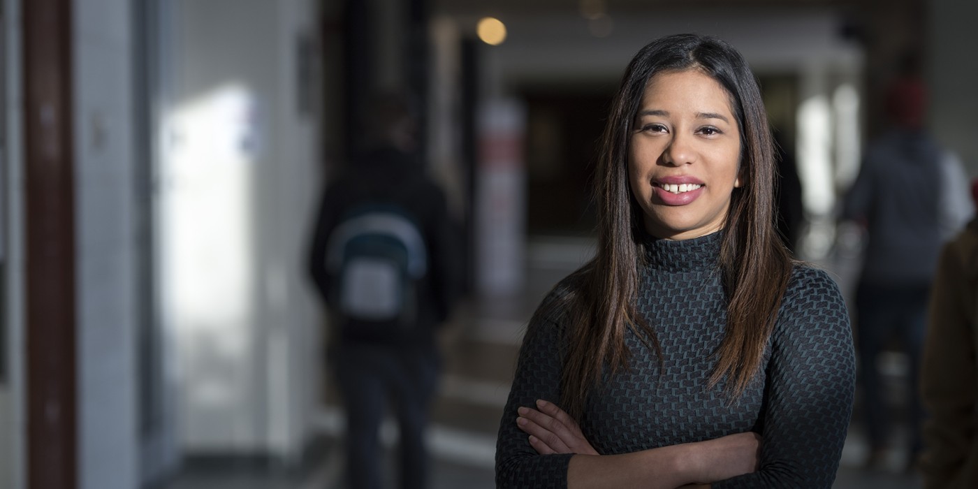 Photo of a community member standing in a hallway