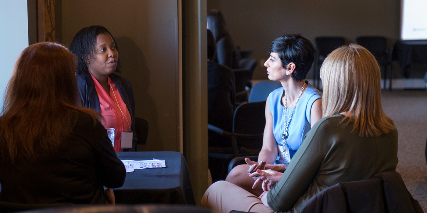 Photo of industry professionals having a discussion at a table