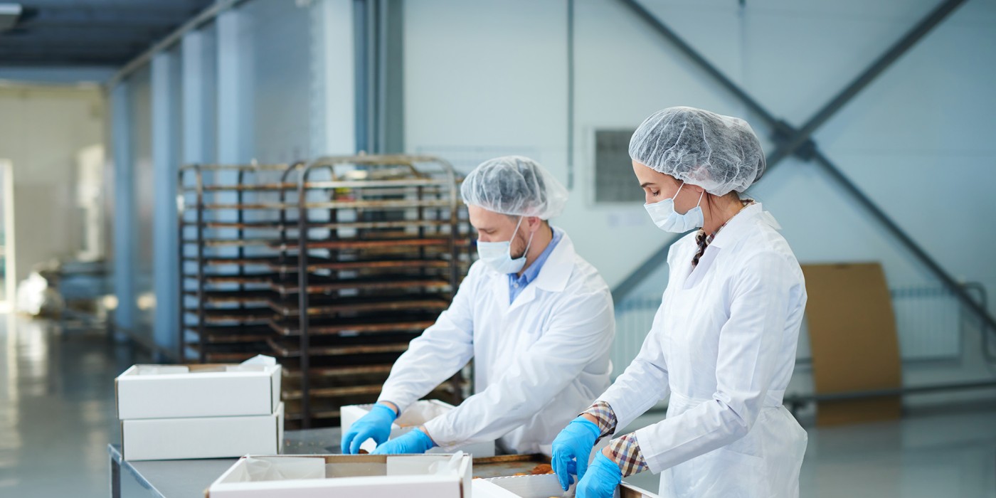 Workers packaging food into boxes