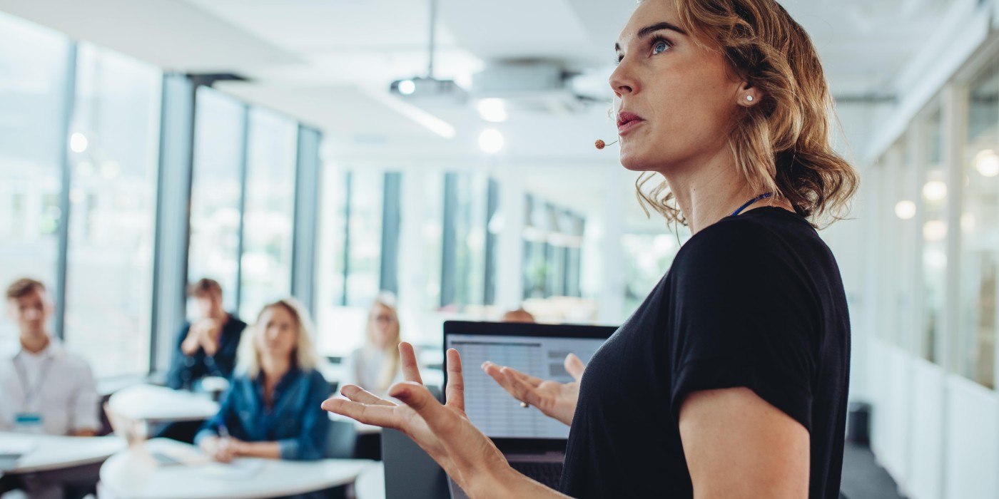 woman standing in front of a group, speaking