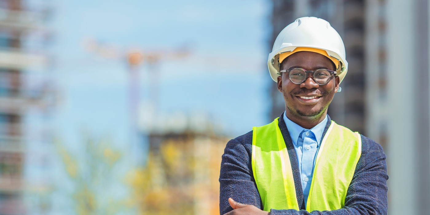 Health and Safety Coordinator posing in front of a construction site