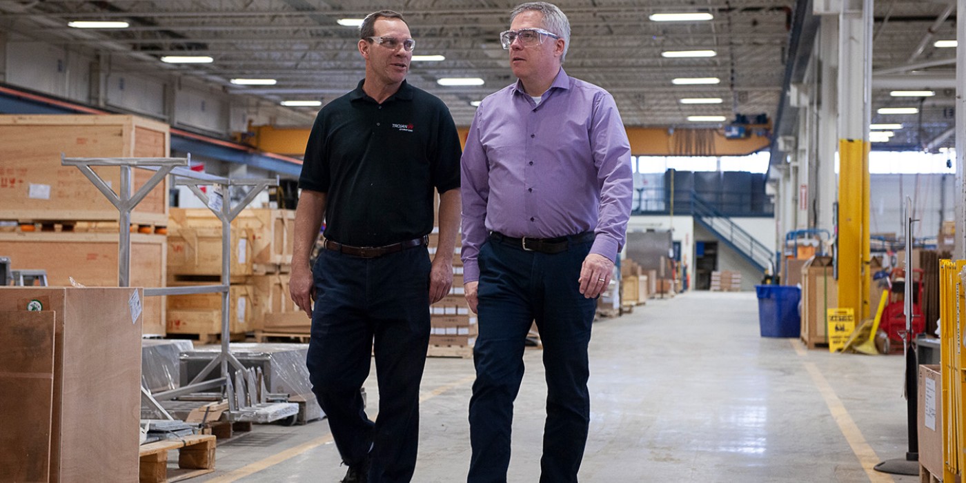 Fanshawe alumni walking through a warehouse
