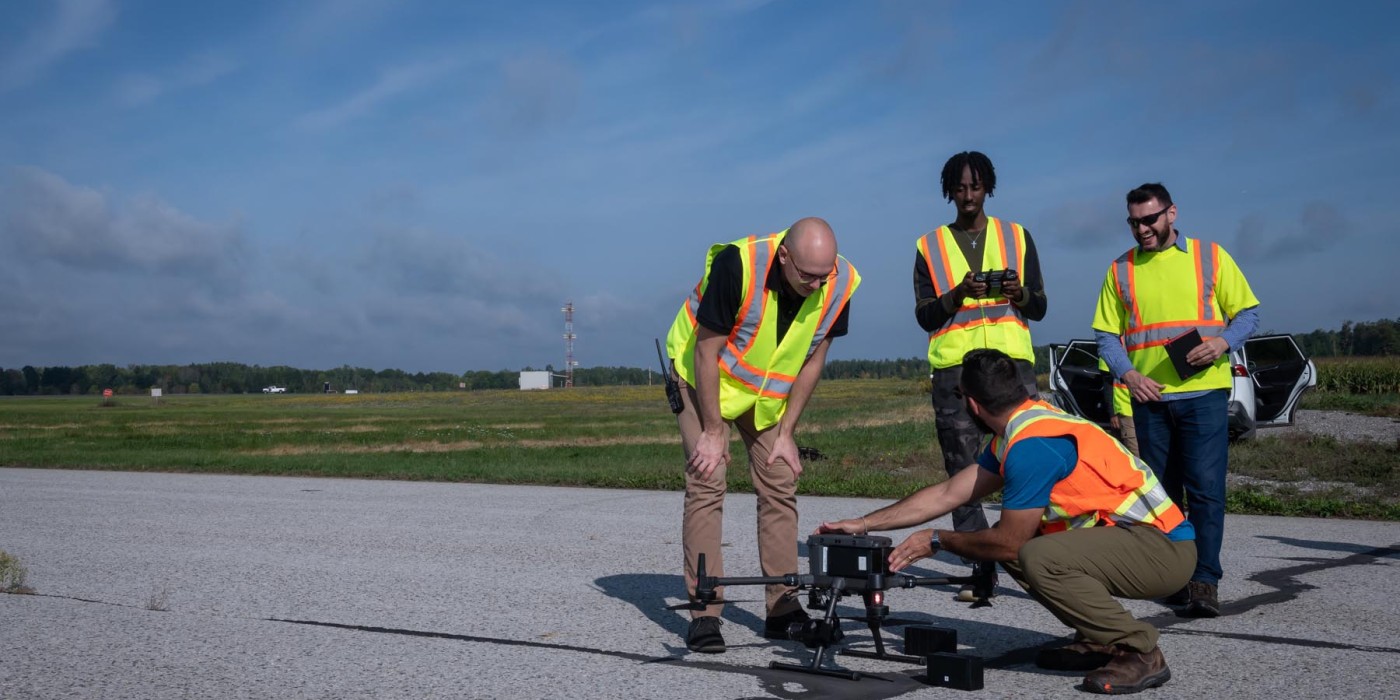 Students setting up a drone on the runway