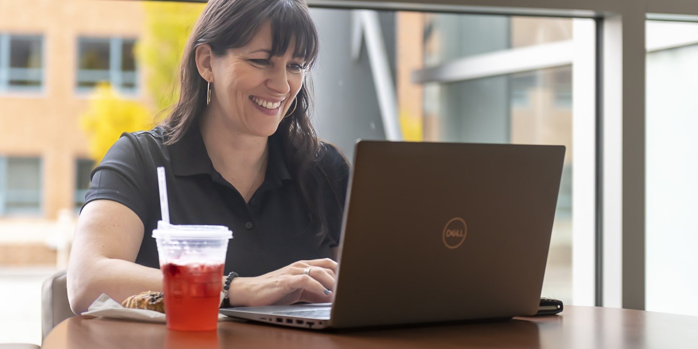 students sits at table with laptop and snacks