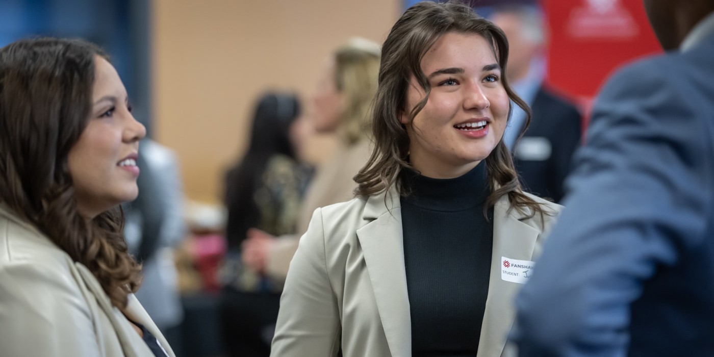 business students chat at networking event