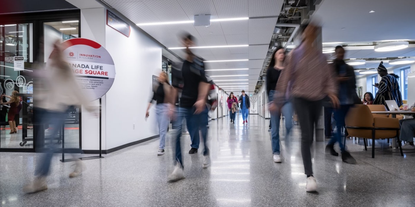 students walk down hallway in Innovation Village at Fanshawe