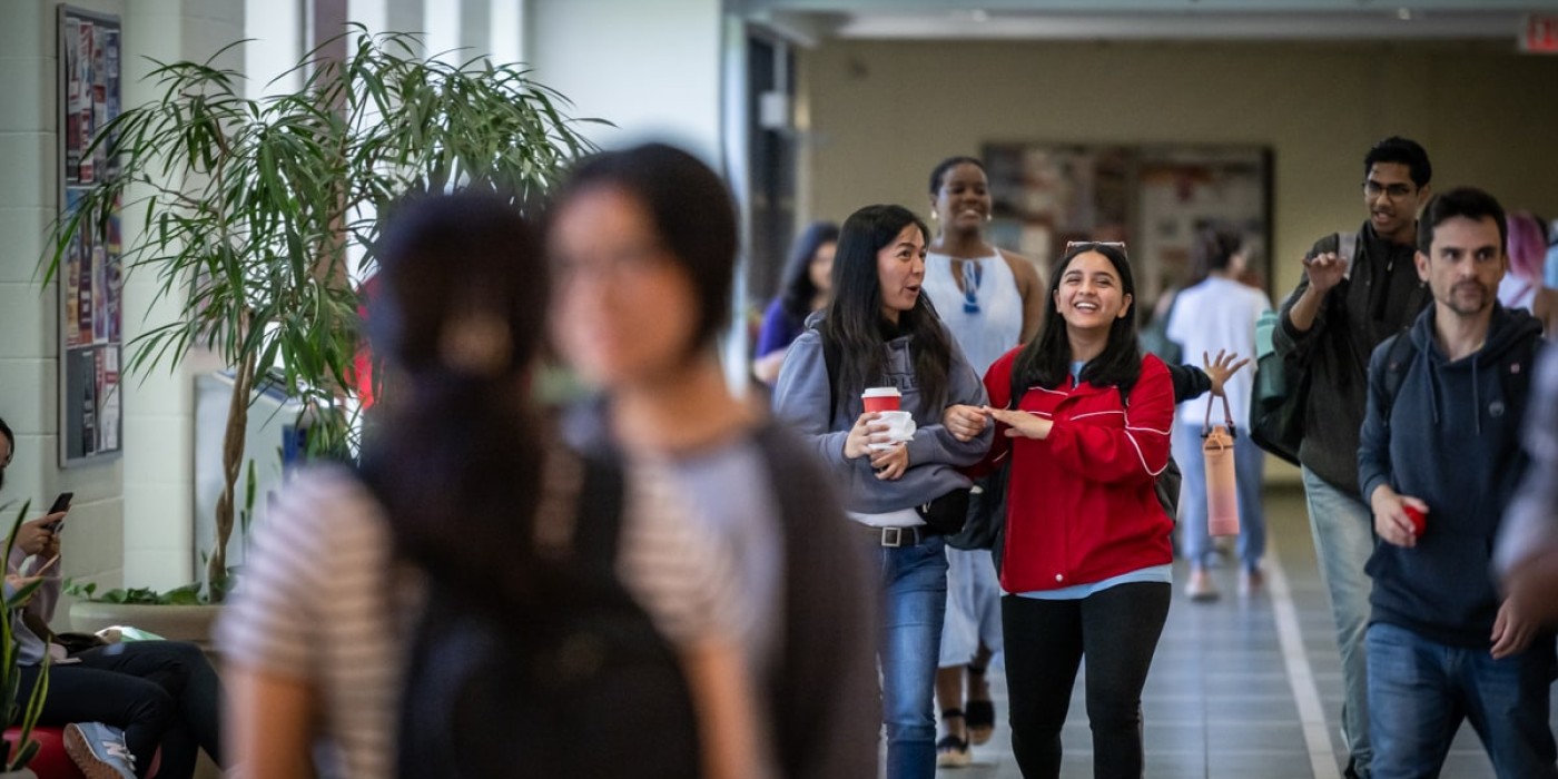 students walk down hallway at Fanshawe