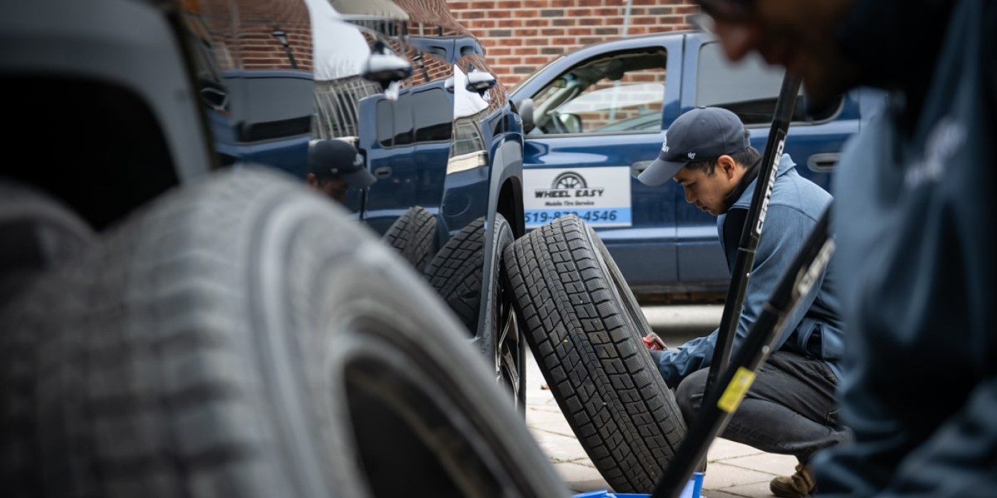 two men are changing tires