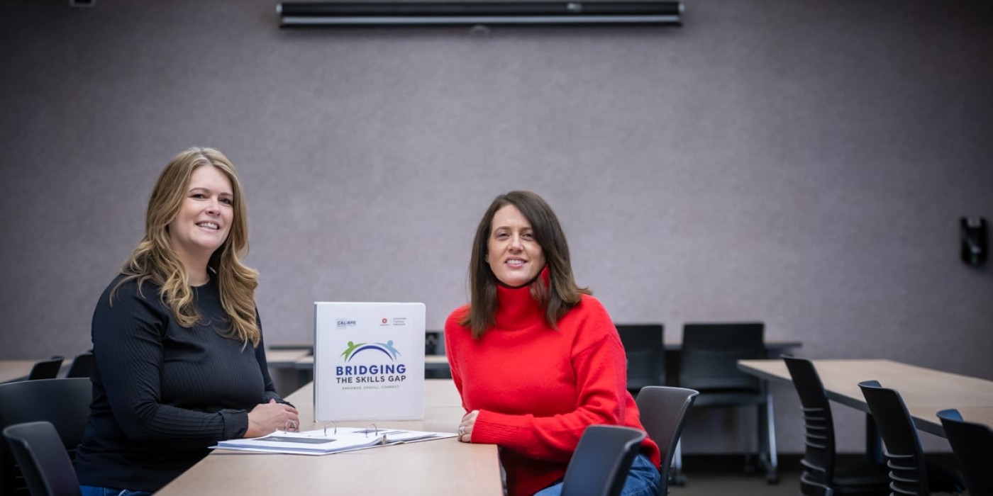 two women are sitting at the table