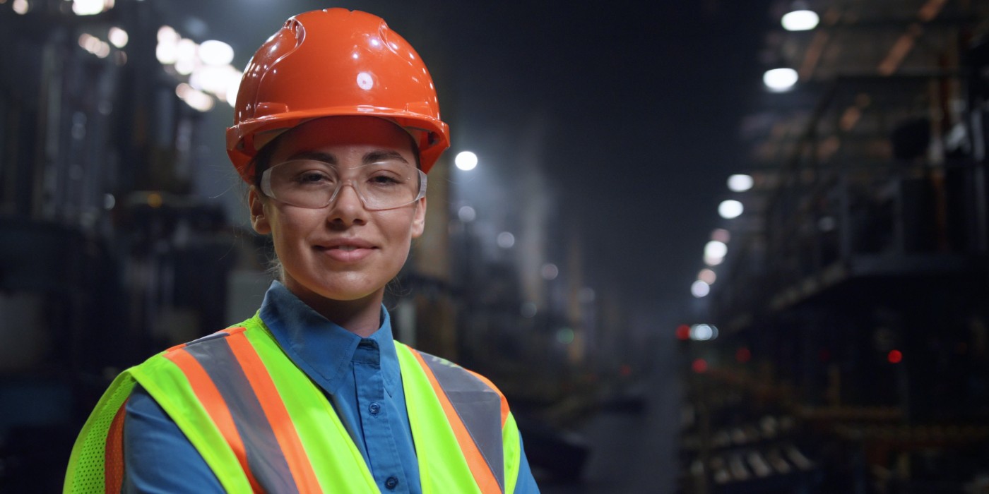woman in hard had and high viz vest