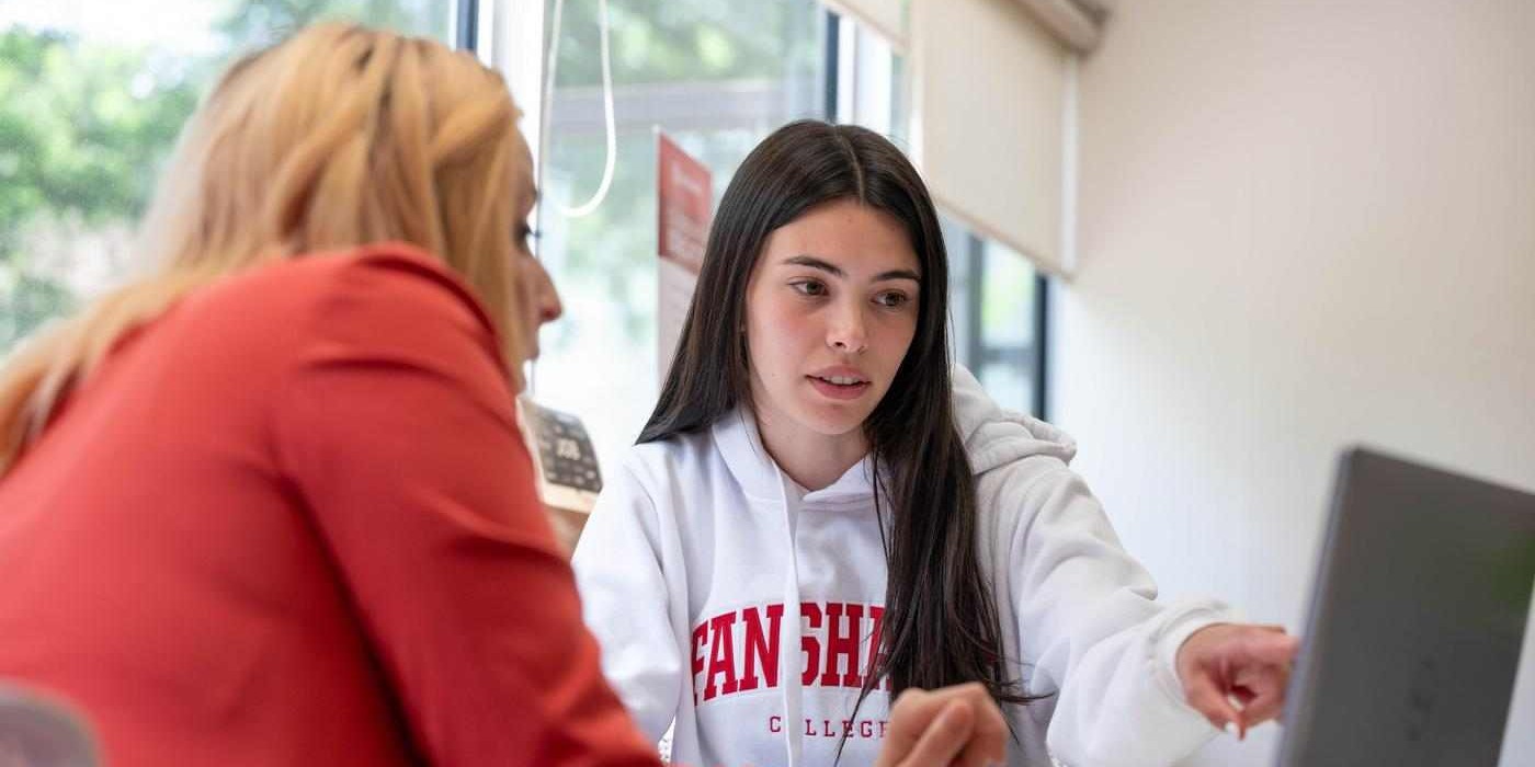 student points at screen while getting support from career services consultant