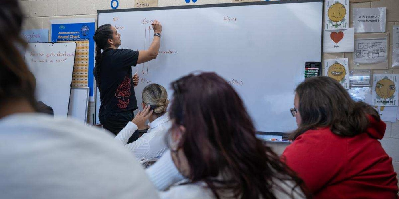 instructor writes on whiteboard in Indigenous Language Program