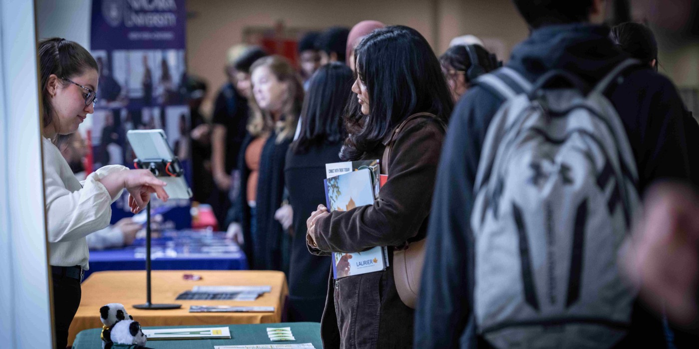 A Fanshawe student interacting with a booth at the pathways fair