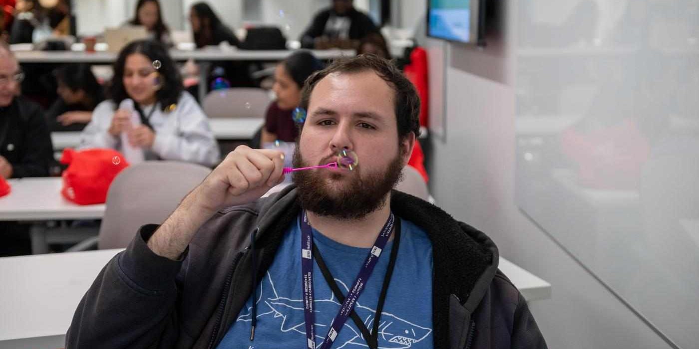 students blow bubbles at self-care conference