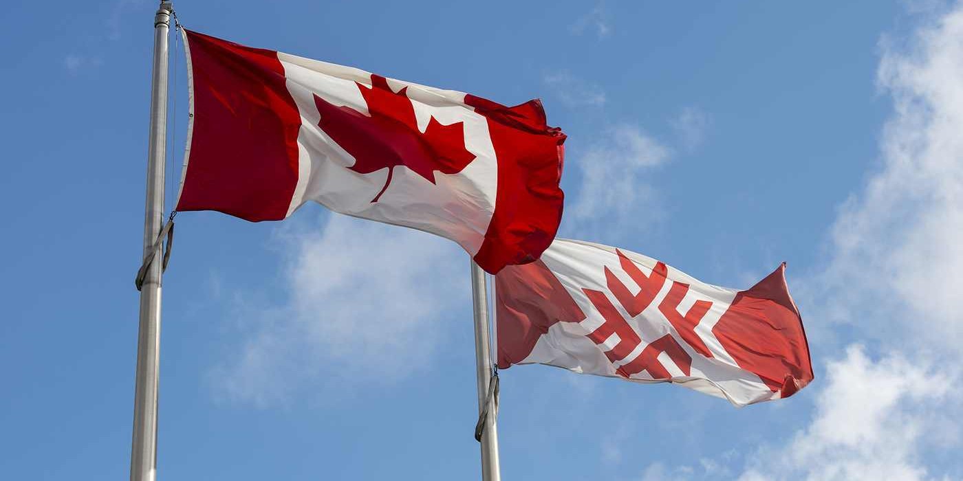 Fanshawe flag flies next to Canadian Flag