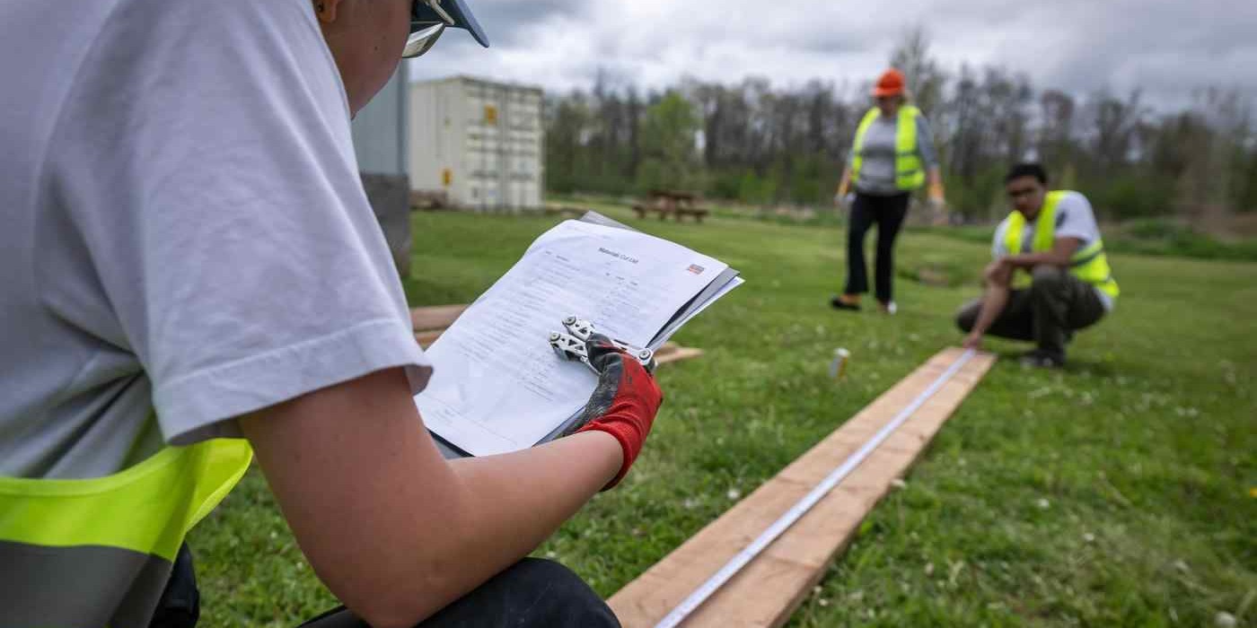students work with lumber at a trades workshop at COTTFN
