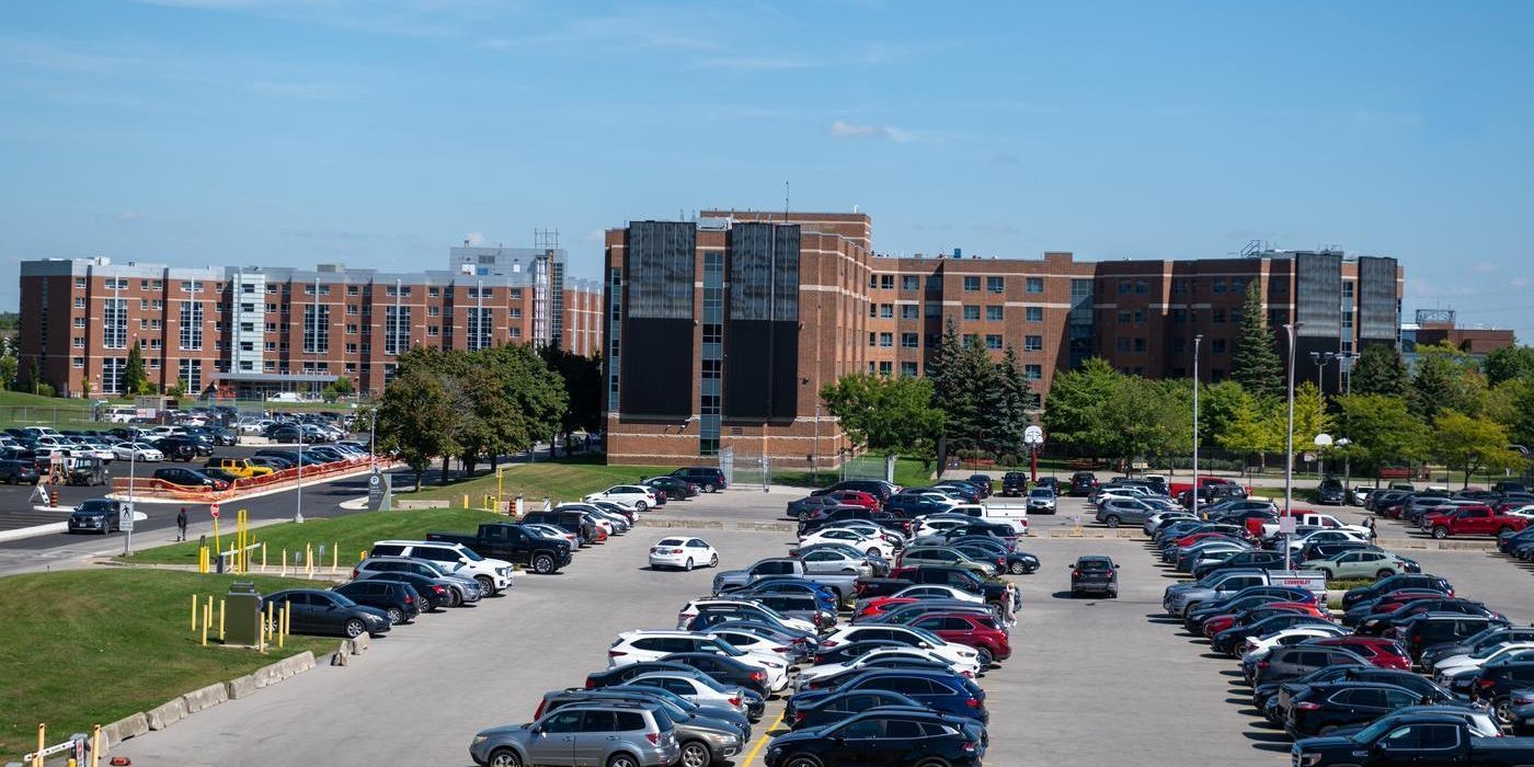 parking lot outside student wellness centre filled with parked vehicles
