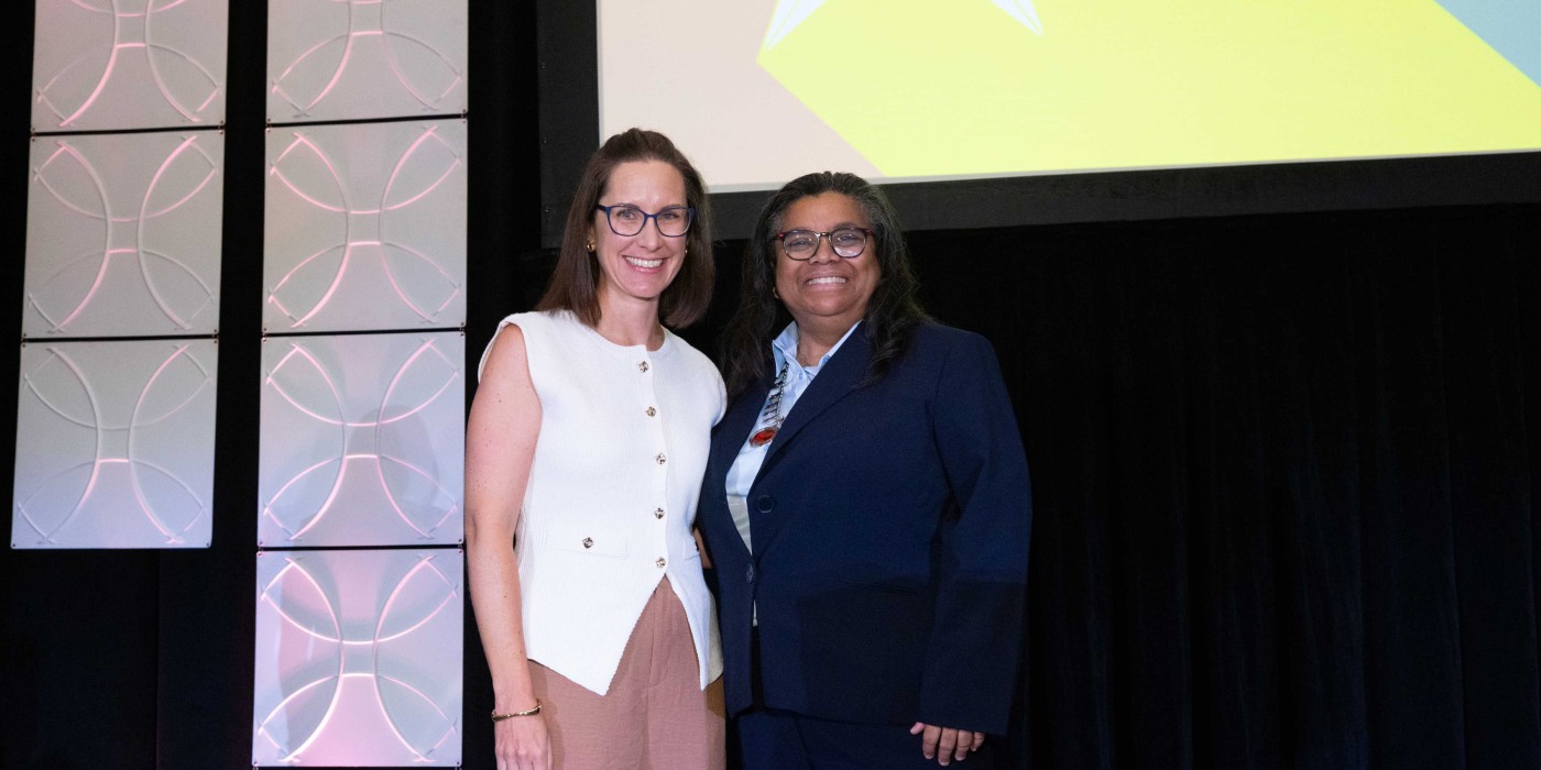 Tracie Skolny, left, receives the Teacher of the Year Award from the American Massage Therapy Association