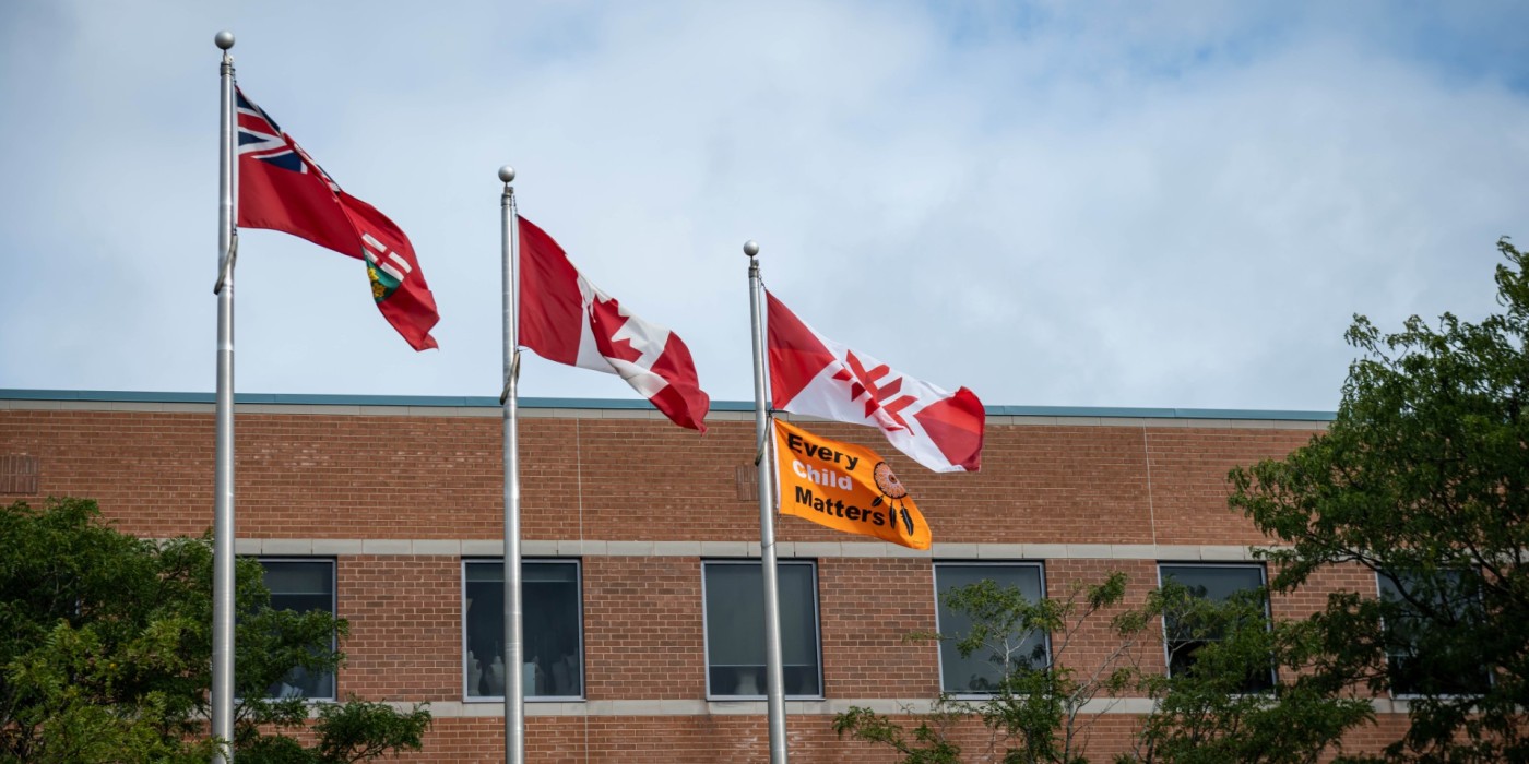 Provincial, Canadian, Fanshawe and Every Child Matters flags