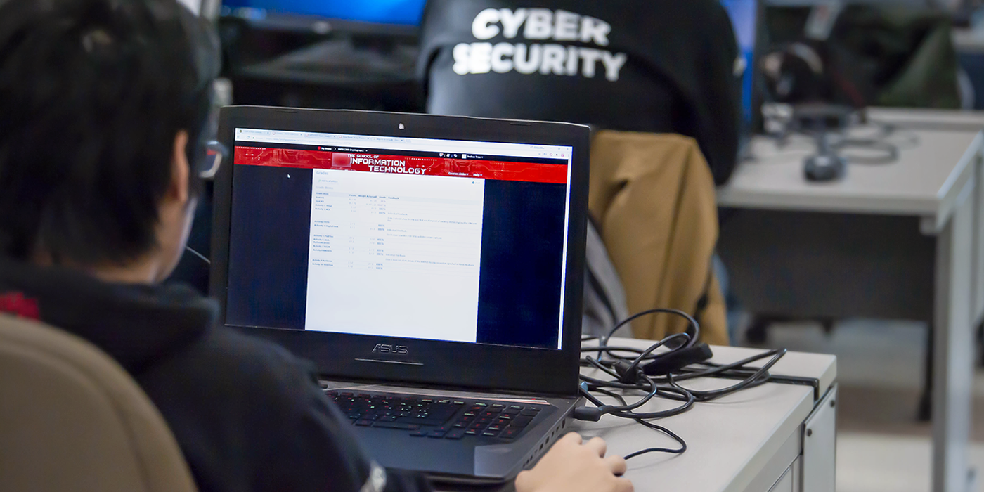 Backs of heads of students in a computer lab scrolling on web pages
