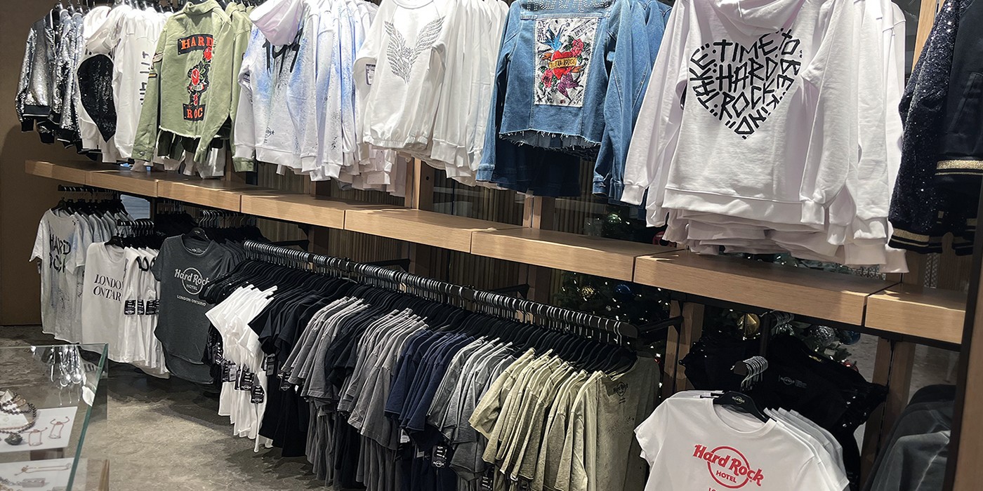 Rows of clothing hanging on a display in the Hard Rock Hotel Rock Shop
