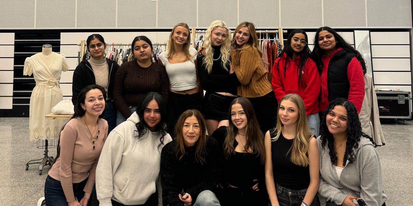 A group of smiling students poses for the camera.