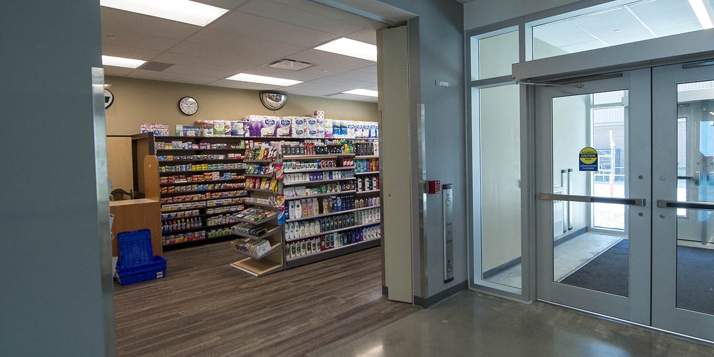 A look into the on campus pharmacy showing shelves of medications and supplies