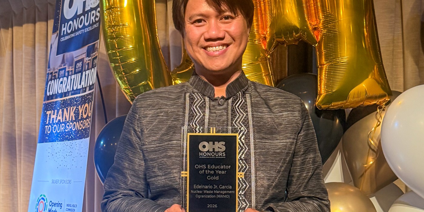 Individual holding a 2026 OHS Educator of the Year Gold award at the OHS Honours ceremony.