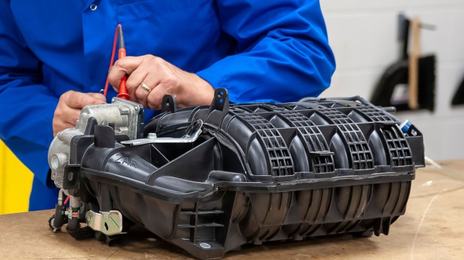 Student testing diesel engine intake part