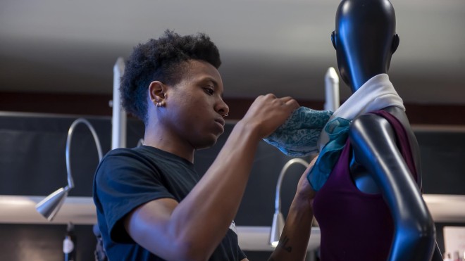 Fashion Marketing and Management student, setting up merchandise in Live Chic store