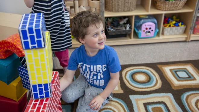 Young child playing with blocks in daycare setting