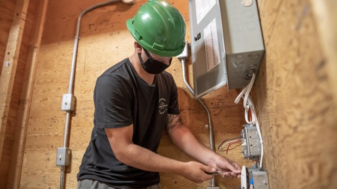 Electrician - Construction and Maintenance student working on electrical panel