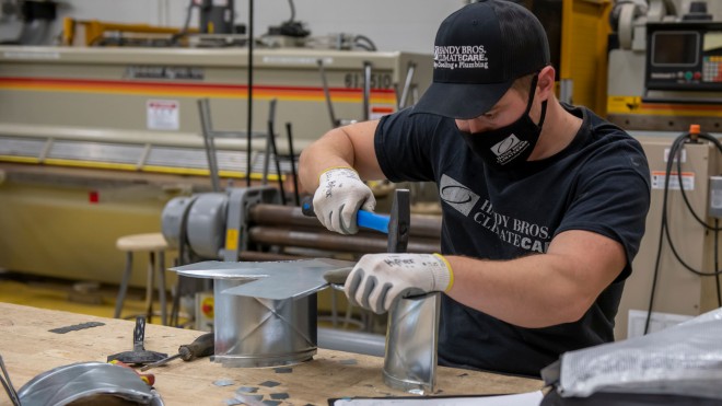Student working on sheet metal