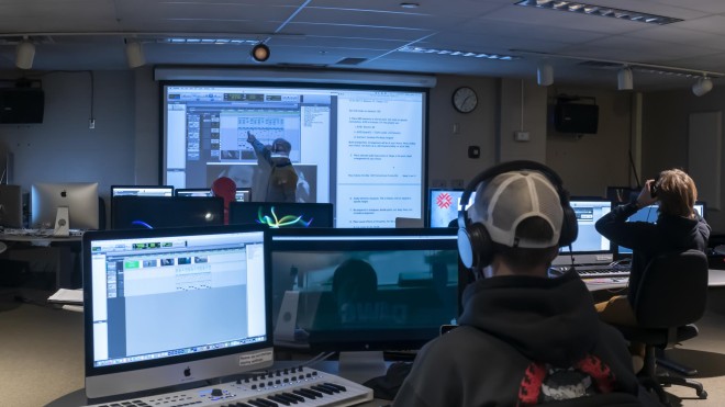 Students in class with professor at white board in audio post-production computer at Fanshawe Collegelab