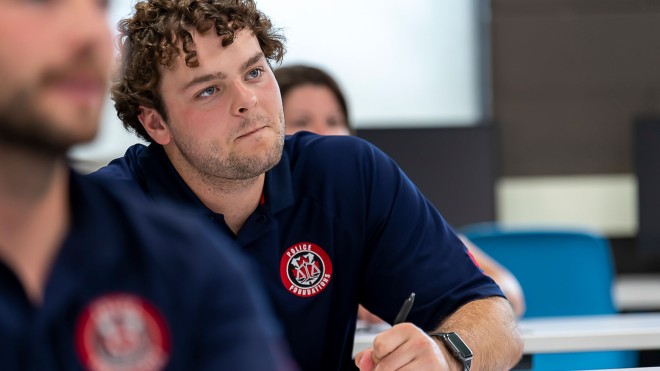 Police foundation student at desk with curious look on his face