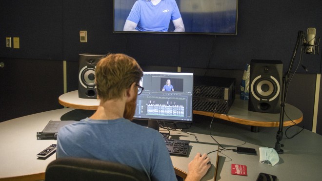 Broadcasting - Television and Film Production student editing video in studio