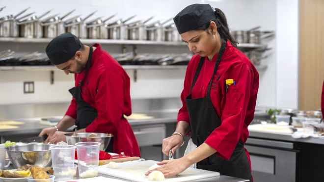 Culinary students preparing food in culinary lab