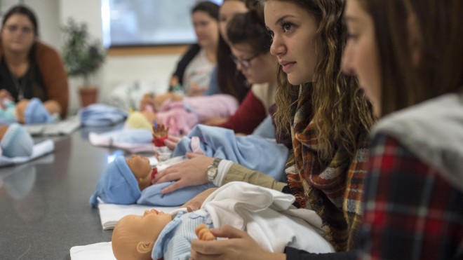 Students in doula class, paying attention to instructor